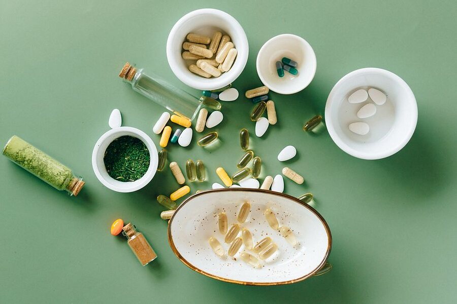 Capsules, tablets and powders laid out in small bowls